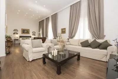 a living room with white couches and a coffee table at Luxe Madre de Dios in Sanlúcar de Barrameda