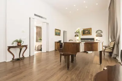 a living room with a piano and a desk at Luxe Madre de Dios in Sanlúcar de Barrameda