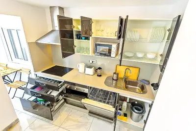 a small kitchen with a sink and a counter at Plaza España 3-bedroom central & bello apartamento in El Puerto de Santa María