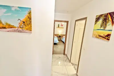 a room with a picture of a bike on the wall at Plaza España 3-bedroom central & bello apartamento in El Puerto de Santa María