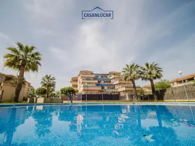 a large swimming pool in front of a building at Piso Real Fernando in Sanlúcar de Barrameda