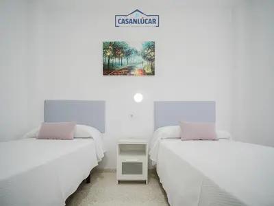 two beds sitting next to each other in a room at Piso Real Fernando in Sanlúcar de Barrameda