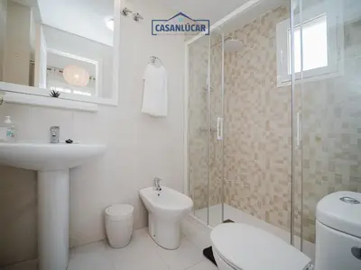 a bathroom with a sink and a toilet and a shower at Piso Real Fernando in Sanlúcar de Barrameda