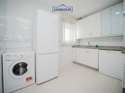 a white laundry room with a washer and dryer at Piso Real Fernando in Sanlúcar de Barrameda