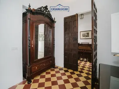 a room with an open door and a mirror at Casa Puerto Lucero in Sanlúcar de Barrameda