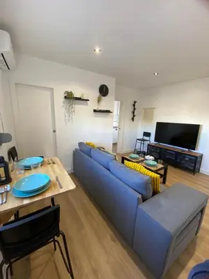 a living room with a blue couch and a table at Casa Mateo in Jedula