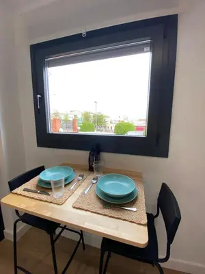 a table with two blue plates and a window at Casa Mateo in Jedula