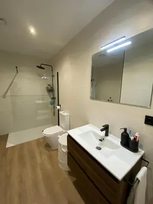a bathroom with a sink and a toilet and a mirror at Casa Mateo in Jedula
