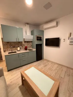 a living room with a kitchen with a table at Estudio en Jerez de la Frontera in Jerez de la Frontera