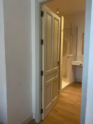 an open door to a bathroom with a sink at Taina La Merced Suite in Jerez de la Frontera