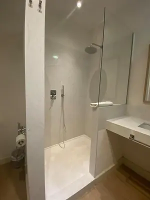 a white bathroom with a shower and a sink at Taina La Merced Suite in Jerez de la Frontera