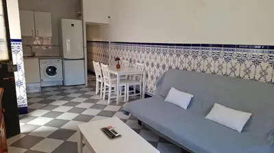 a living room with a couch and a table at La Marea in Chipiona