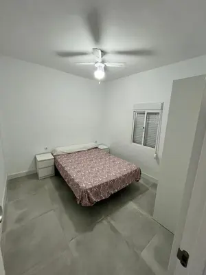 a bedroom with a bed and a ceiling fan at Casa Ianira in El Puerto de Santa María