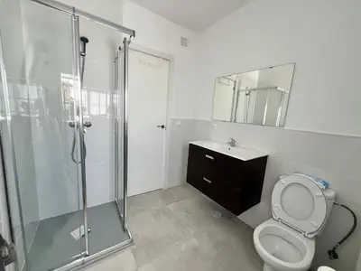 a bathroom with a shower and a toilet and a sink at Casa Ianira in El Puerto de Santa María