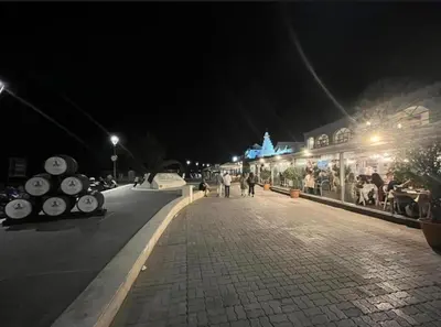 a street at night with people walking down the street at Mirador Sanlúcar 10 in Sanlúcar de Barrameda