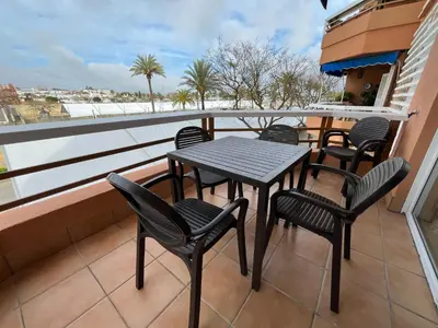 a table and chairs on a balcony with a view at Mirador Sanlúcar 10 in Sanlúcar de Barrameda