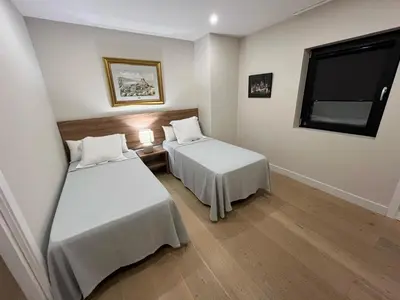 a room with two beds and a window at Mirador Sanlúcar 10 in Sanlúcar de Barrameda