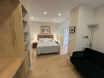 a bedroom with a bed and a couch in a room at Mirador Sanlúcar 10 in Sanlúcar de Barrameda