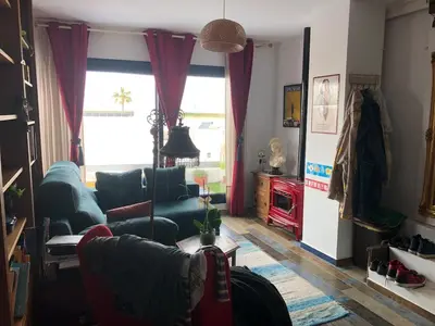 a living room with a couch and a table at Mediterranean house in Bajo Guía in Sanlúcar de Barrameda