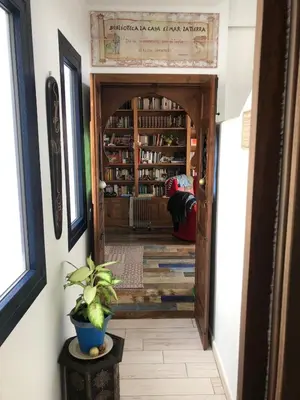 a hallway with a door leading into a library at Mediterranean house in Bajo Guía in Sanlúcar de Barrameda