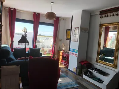 a living room with a blue couch and a mirror at Mediterranean house in Bajo Guía in Sanlúcar de Barrameda