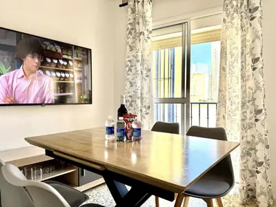 a dining room table with bottles of water on it at Sousa by Staycare in Chipiona