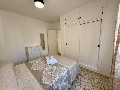 a bedroom with a bed and a dresser and a mirror at Sousa by Staycare in Chipiona