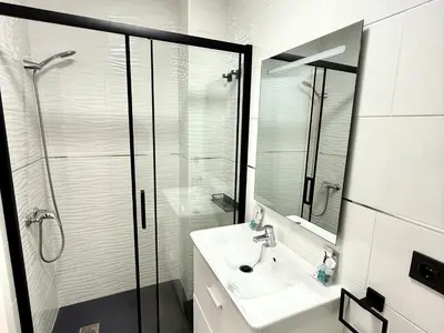 a white bathroom with a shower and a sink at Sousa by Staycare in Chipiona