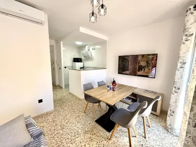 a dining room with a table and chairs in a room at Sousa by Staycare in Chipiona