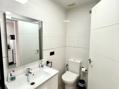 a white bathroom with a toilet and a sink at Sousa by Staycare in Chipiona