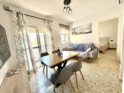 a living room with a table and a couch at Sousa by Staycare in Chipiona
