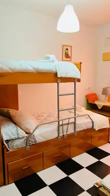 a bunk bed in a room with a checkered floor at Casa Nieves, totalmente equipada Planta 2 in Arcos de la Frontera