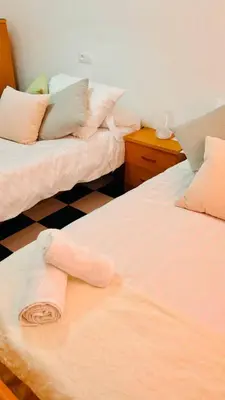 a hotel room with two beds with towels on them at Casa Nieves, totalmente equipada Planta 2 in Arcos de la Frontera