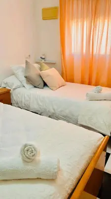 two beds sitting next to each other in a room at Casa Nieves, totalmente equipada Planta 2 in Arcos de la Frontera