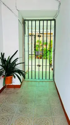 an open gate in a room with a plant at Casa Nieves, totalmente equipada Planta 2 in Arcos de la Frontera