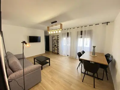 a living room with a couch and a table at Apartmento Carmen Viejo, Centro in Sanlúcar de Barrameda