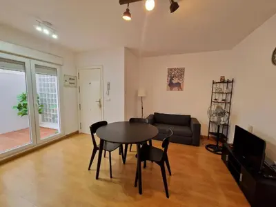 a living room with a table and chairs and a couch at CDZ - San Telmo in Cádiz