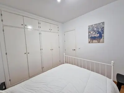 a white bedroom with white cabinets and a bed at CDZ - San Telmo in Cádiz