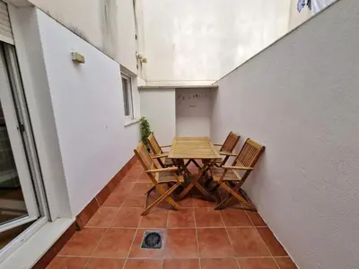 a table and chairs in a room with a floor at CDZ - San Telmo in Cádiz