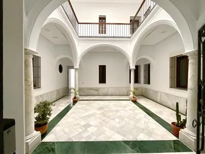 an empty hallway with a staircase in a building at El Buen Porvenir Casa Palacio en Jerez in Jerez de la Frontera