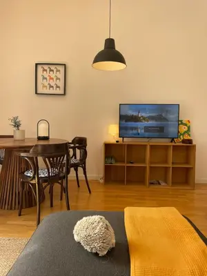a living room with a television and a dining room table at El Buen Porvenir Casa Palacio en Jerez in Jerez de la Frontera