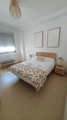 a bedroom with a large bed in a room at Apartamento Azalea in El Puerto de Santa María