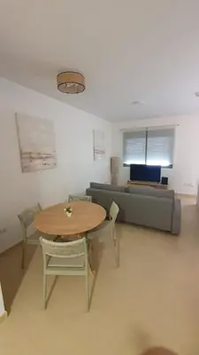 a living room with a table and a couch at Apartamento Azalea in El Puerto de Santa María