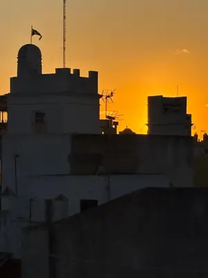 a silhouette of a building with a sunset in the background at Candelaria cornerflat in Cádiz