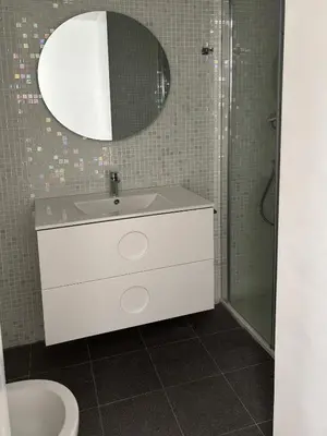 a bathroom with a white sink and a mirror at Candelaria cornerflat in Cádiz