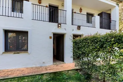 a white house with balconies on the side of it at Hacienda Roche Viejo in Conil de la Frontera