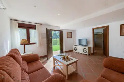 a living room with a couch and a table at Hacienda Roche Viejo in Conil de la Frontera
