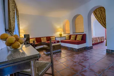 a living room with a couch and a table at Hacienda Roche Viejo in Conil de la Frontera