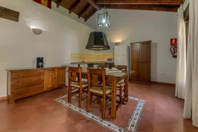 a kitchen with a table and chairs in a room at Hacienda Roche Viejo in Conil de la Frontera