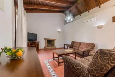 a living room with a couch and a table at Hacienda Roche Viejo in Conil de la Frontera